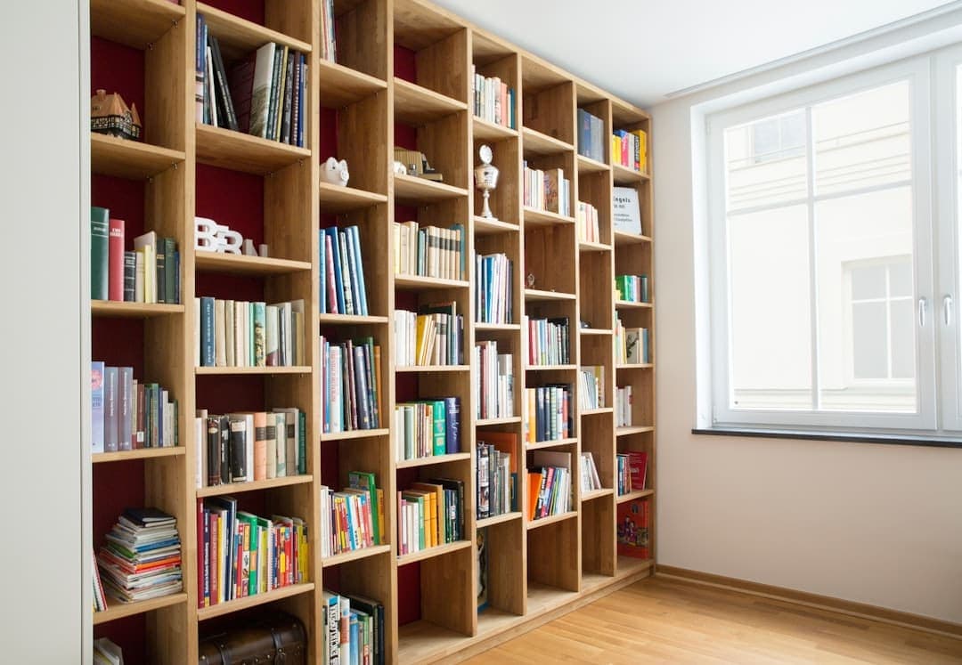 Wooden floor-to-ceiling bookcase filled with books