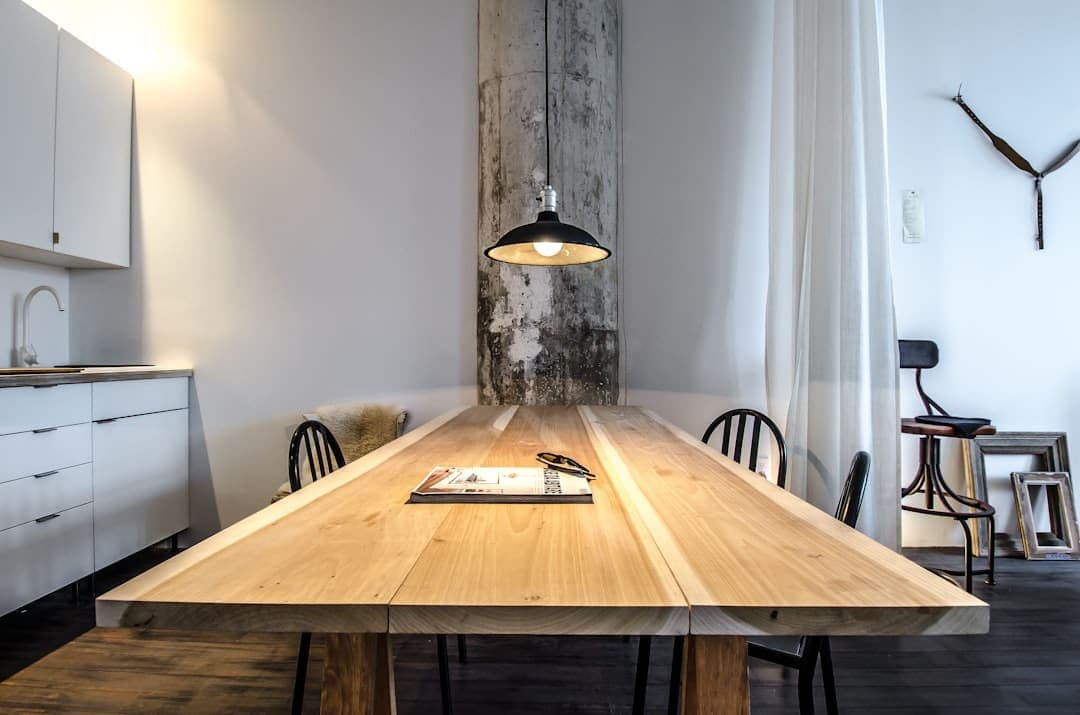 Solid oak dining table under a pendant lamp