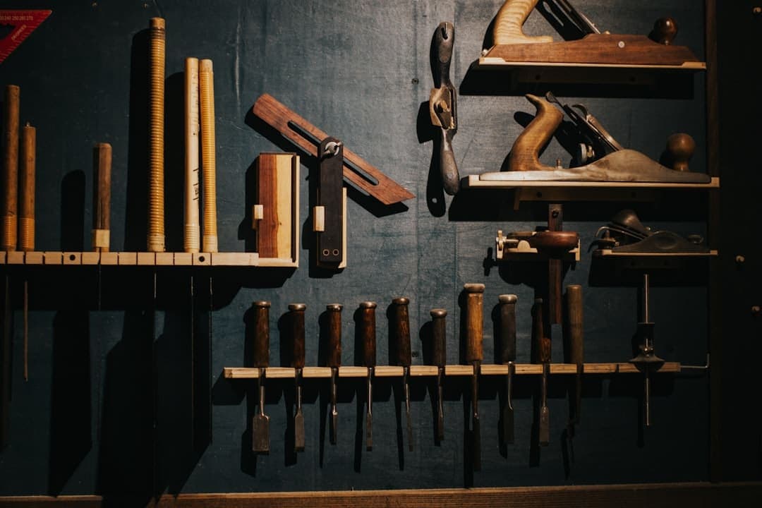 Carpentry tools on a dark workshop wall